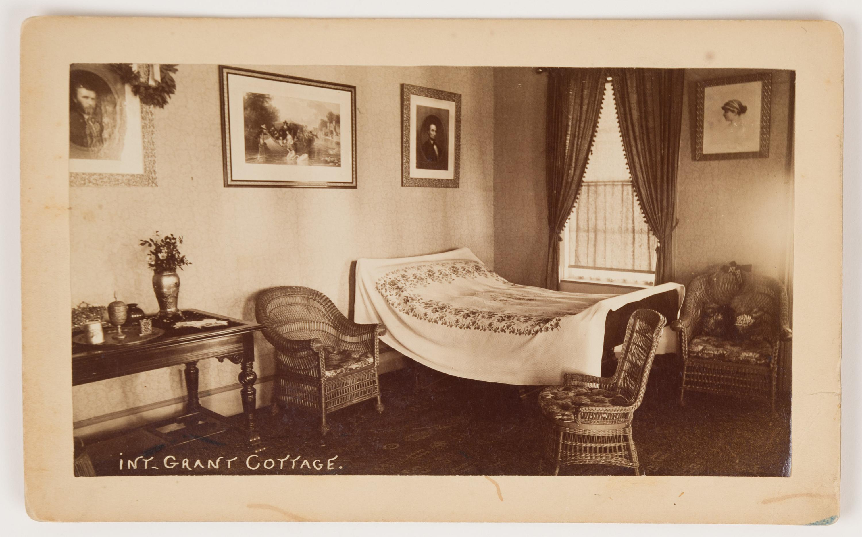 Black and white image of a bedroom interior with a bed and chairs