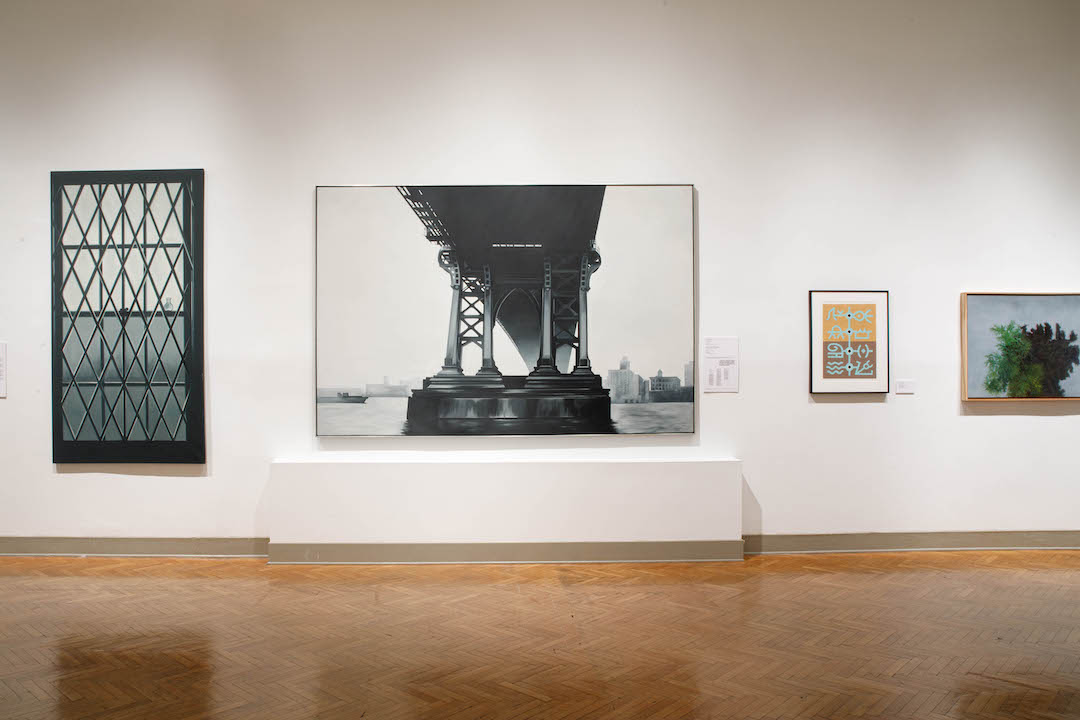 Paintings of a window, a bridge, and a tree installed in a gallery
