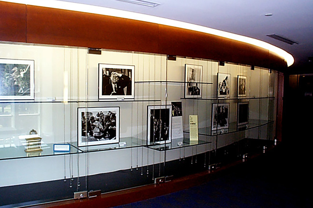 Black and white photographs shown in a curved display case