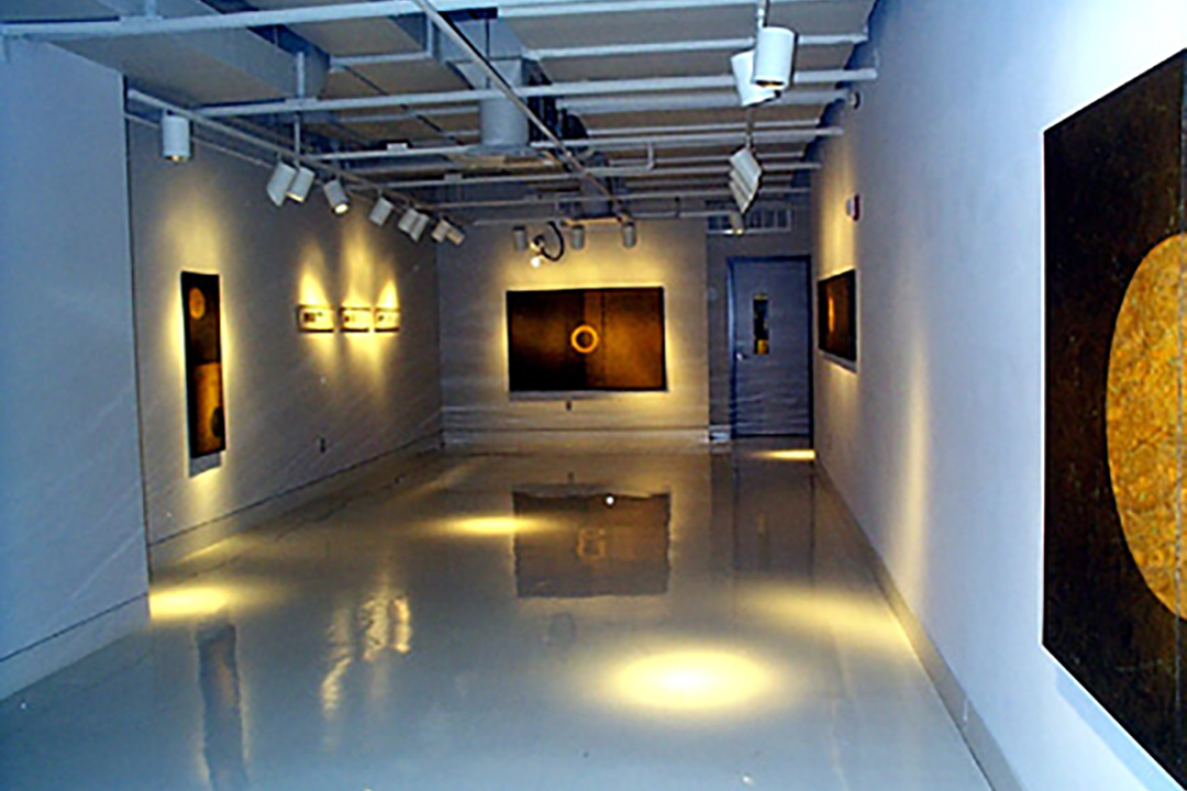Paintings showing circles in the center of each work installed in a gallery