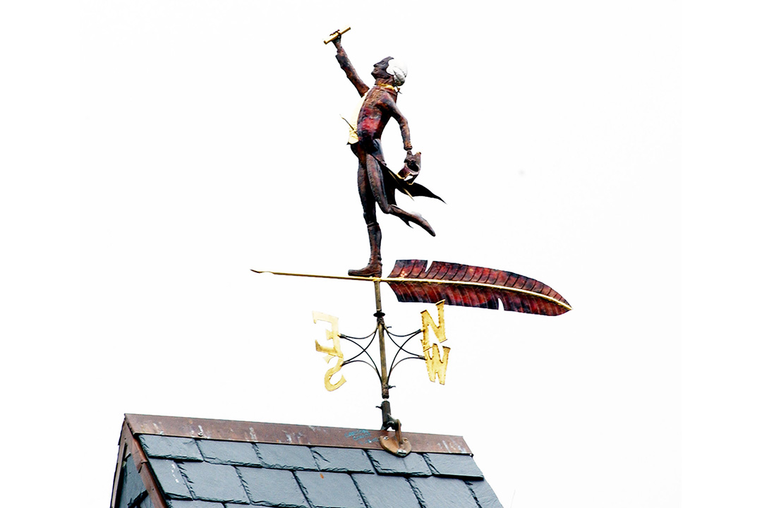 Weathervane of George Washington holding a rolled up paper up in his hand
