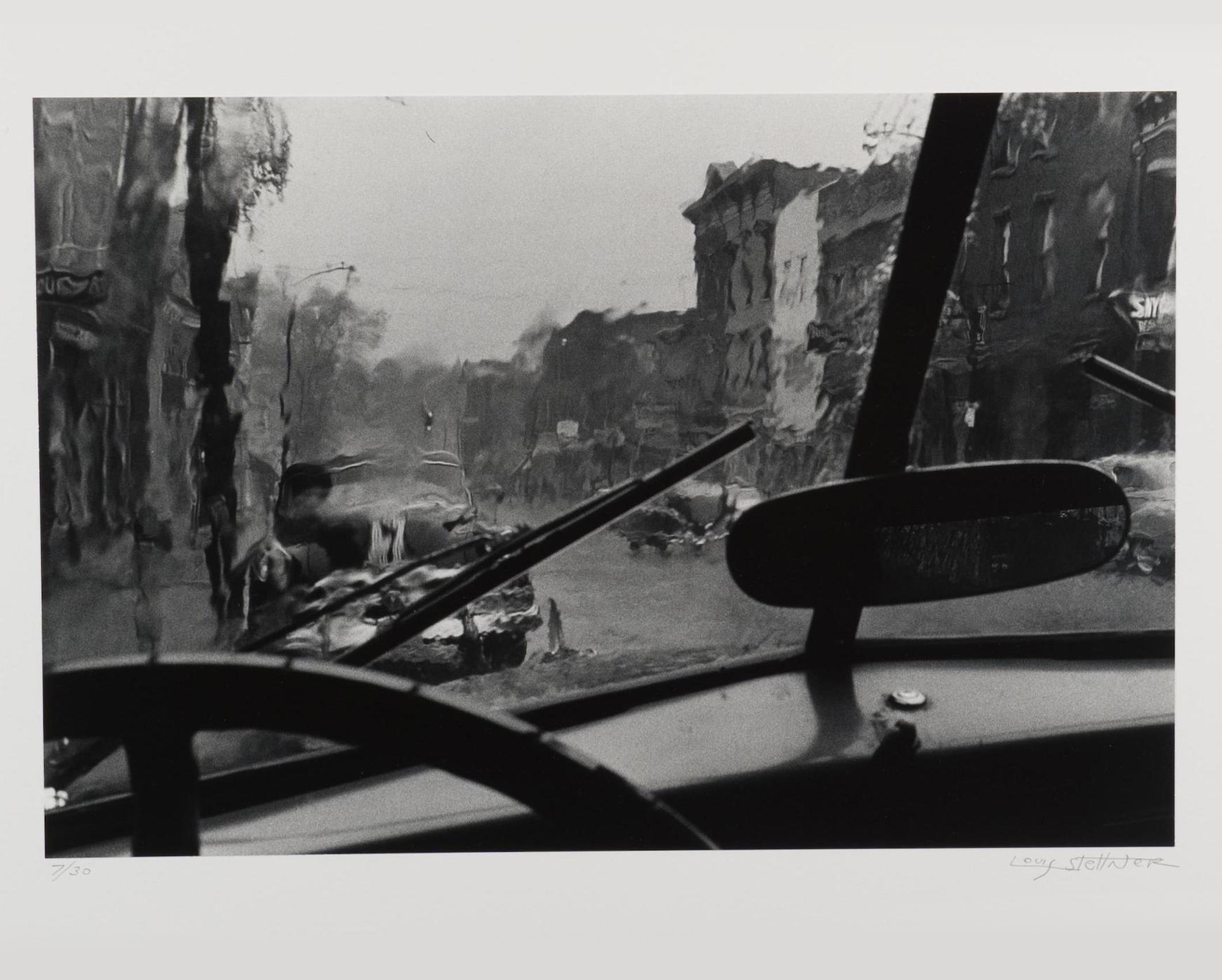Louis Stettner black and white photograph of a city seen through a rain covered windshield [link goes to collection database entry]