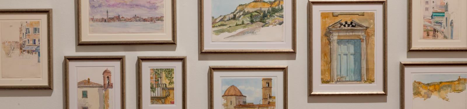 Group of watercolor paintings of Italy on wall of Brady Art Gallery
